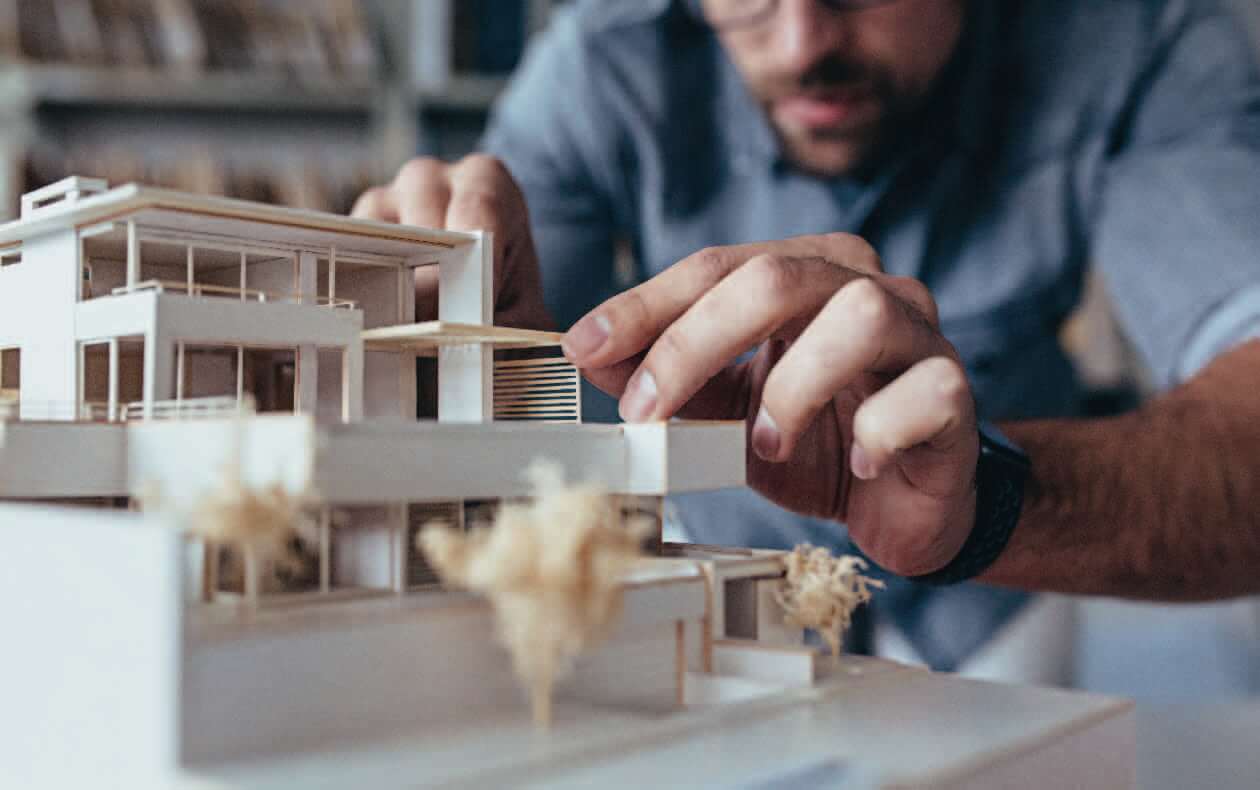 Person building the model of a building